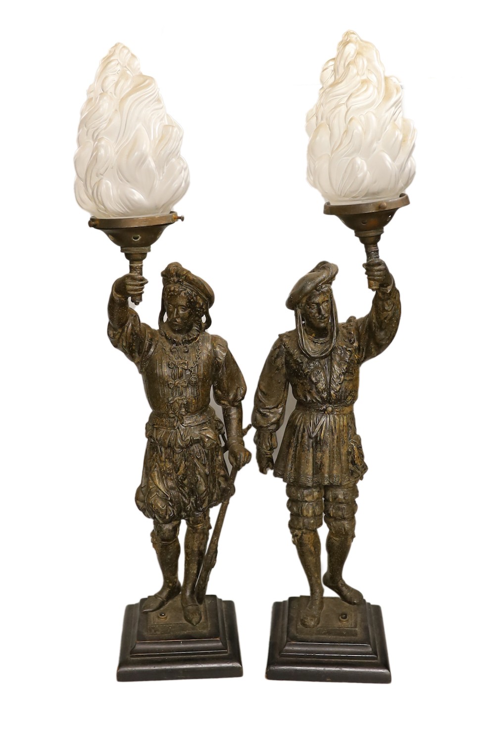 A pair of bronzed spelter figural table lamps, with flame shades, approximately 72cms high